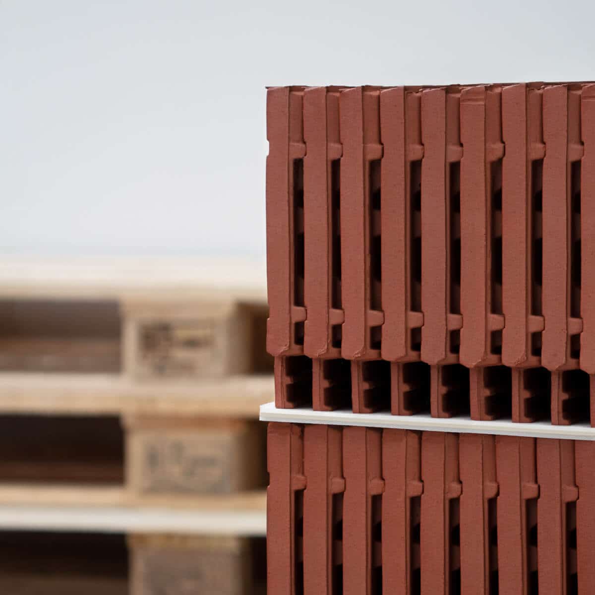 Industrial packaging roof tiles on pallet with intermediate layers of solid board laminated with foam - close-up